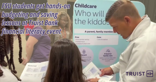 FSU students at a Truist Bank financial literacy event reviewing budgeting materials, with a childcare decision-making display visible in the background.