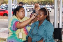 woman getting her face painted